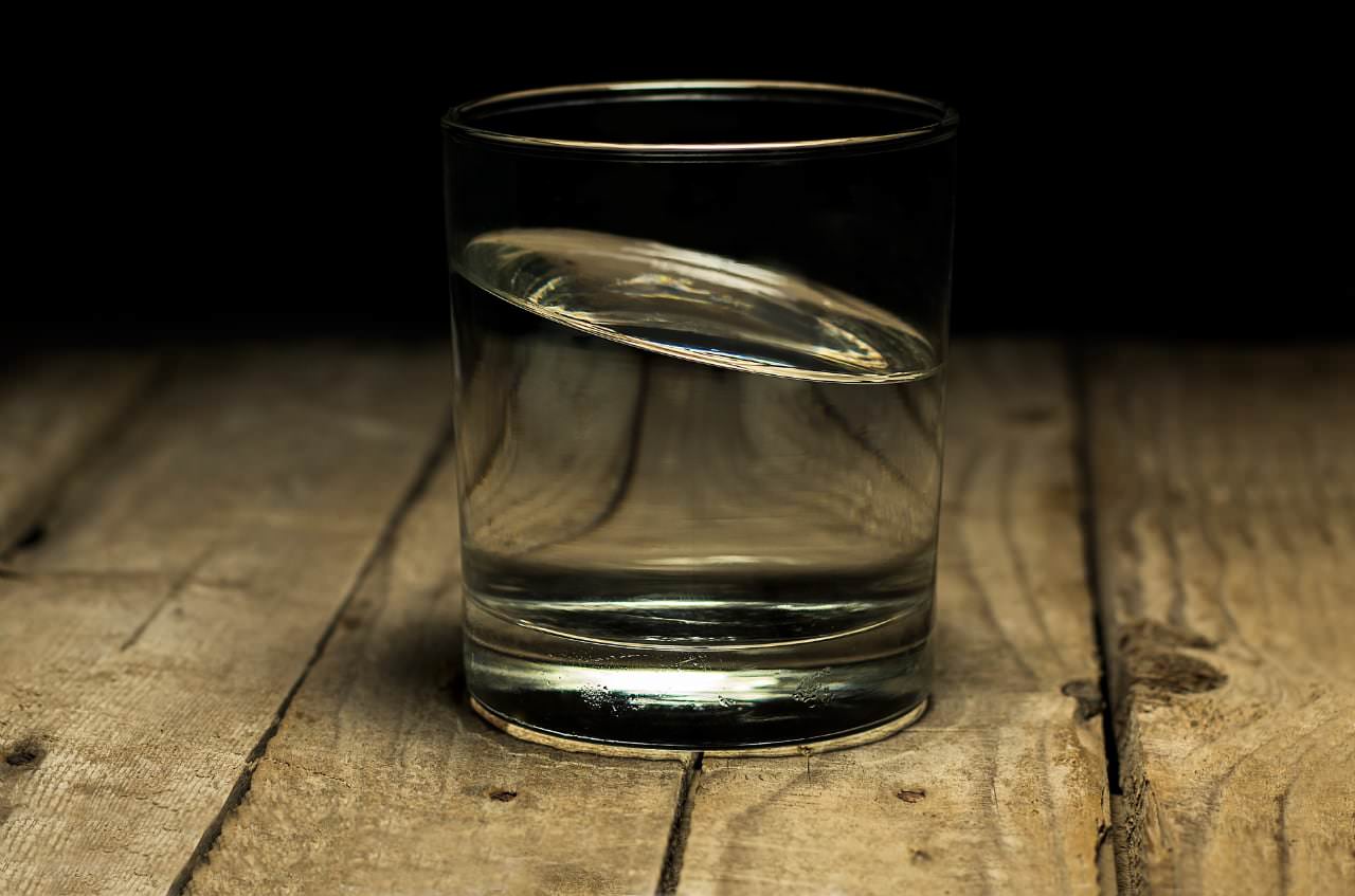 A glass of water on a wooden table