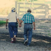 Old couple walking while holding hands