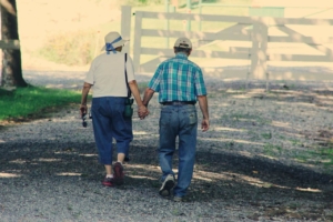 Old couple walking while holding hands