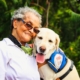 Elderly woman sitting beside a dog