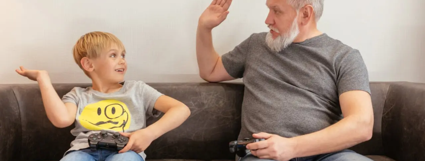 A grandfather and a boy playing console game